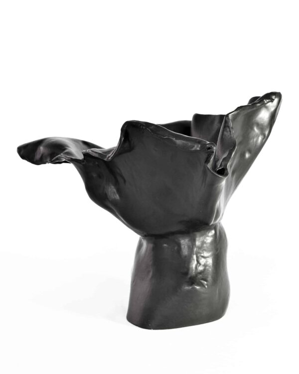 From the "Black Magnolia" series: An elegant black abstract sculpture, its glossy undulations evoke a magnolia in bloom, set on a white backdrop. , an original work available at MÍRAME Fine Art.
