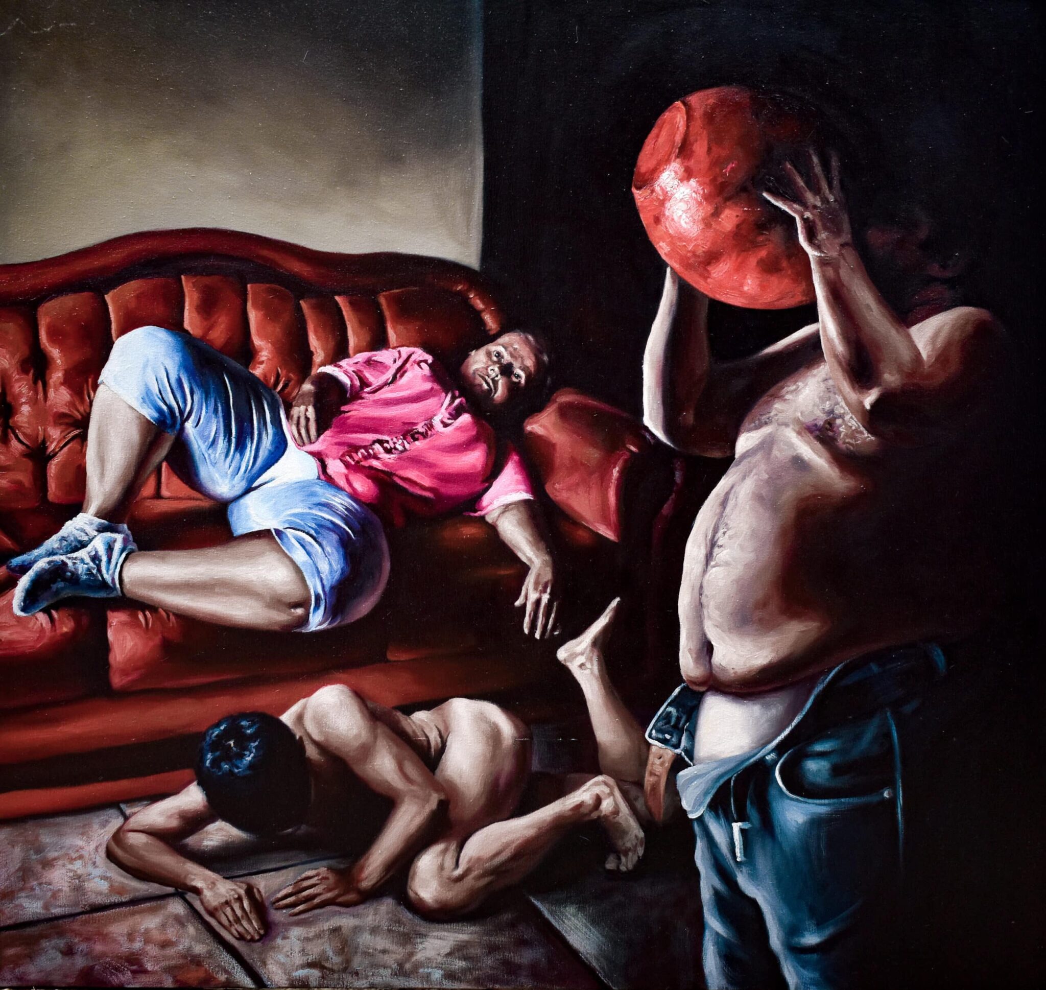In a dimly lit interior, three semi-clad men compose a dynamic scene: one lounging on a red sofa, another prone on the floor, and a third, shirtless, conceals his visage behind an oversized red sphere. , an original work available at MÍRAME Fine Art.