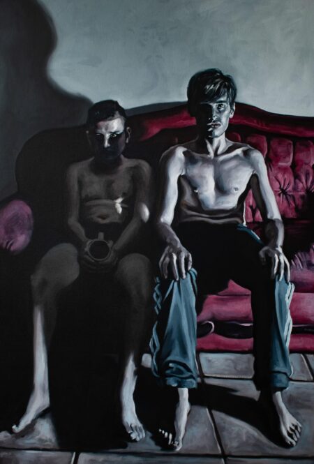 Two shirtless men on a red couch: one, shadowed and contemplative with mug; the other, illuminated in blue pants, bathed in dramatic light. , an original work available at MÍRAME Fine Art.