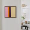 Small pink and yellow geometric abstraction painting hanging on the wall of a contemporary living space.