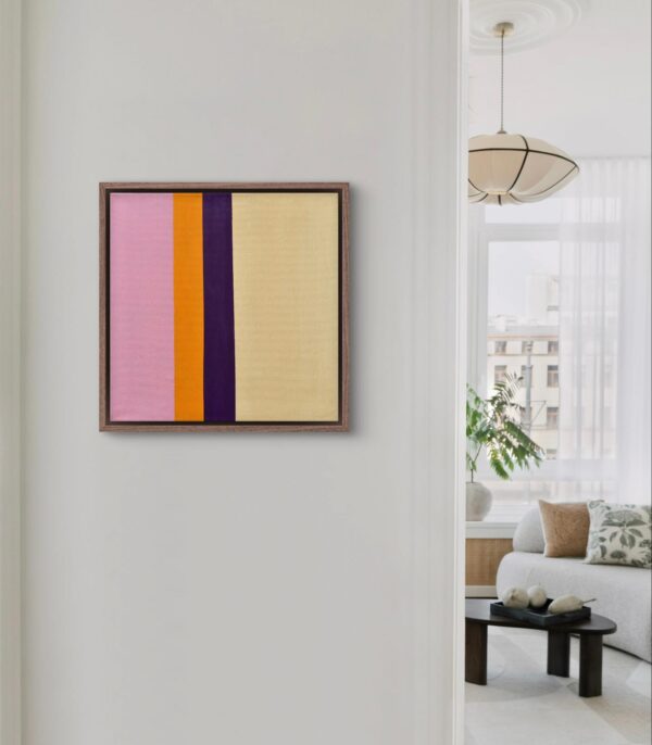 Small pink and yellow geometric abstraction painting hanging on the wall of a contemporary living space.