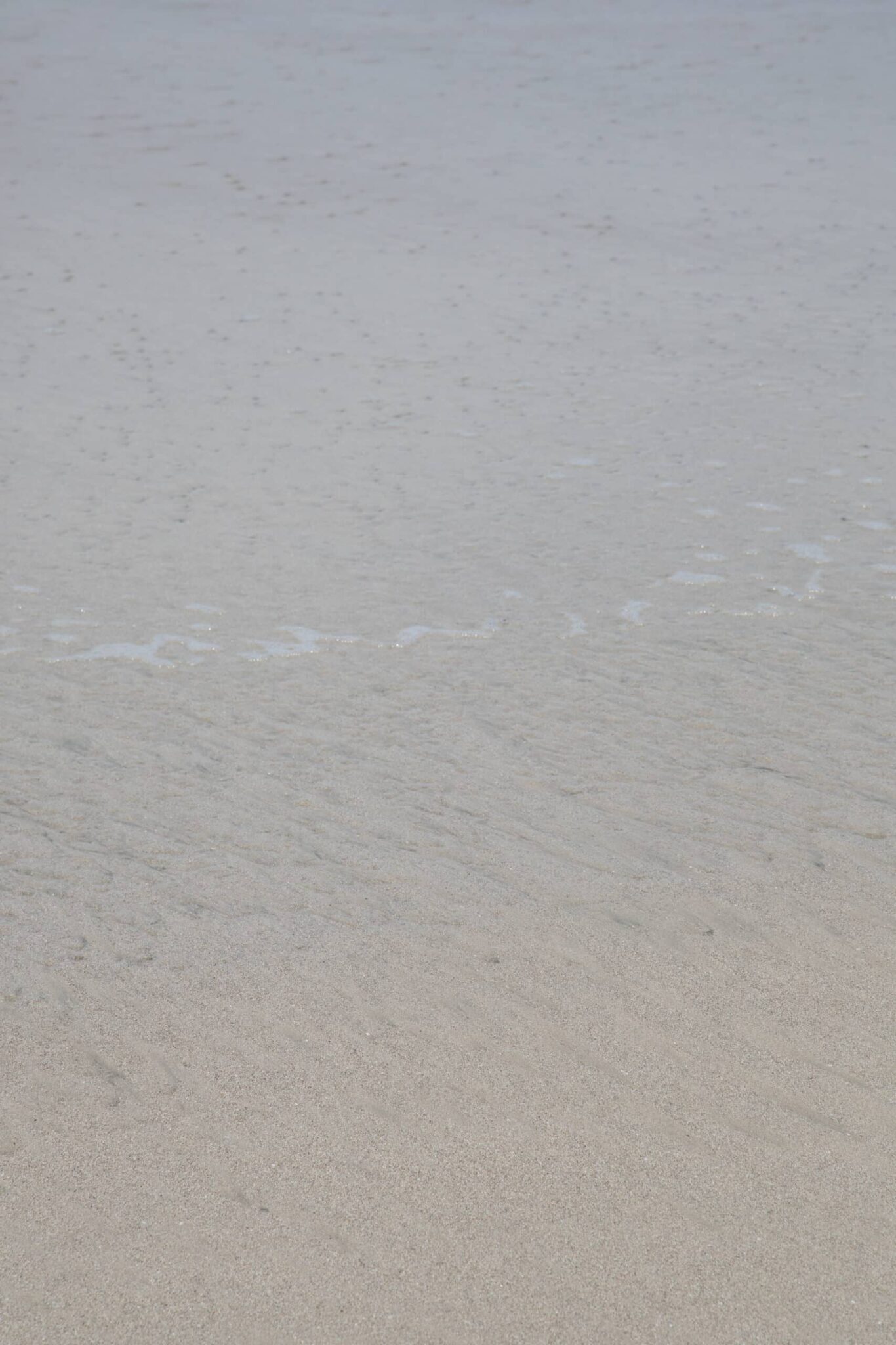 abstract ocean photography of sand under ocean water, by Juan Tribaldos.
