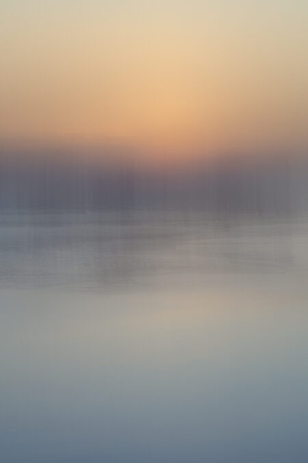 Serene abstract photography by Juan Tribaldos where he has blurred the image of an ocean and soft light of either a sunrise or a sunset into complete dreamy abstraction.