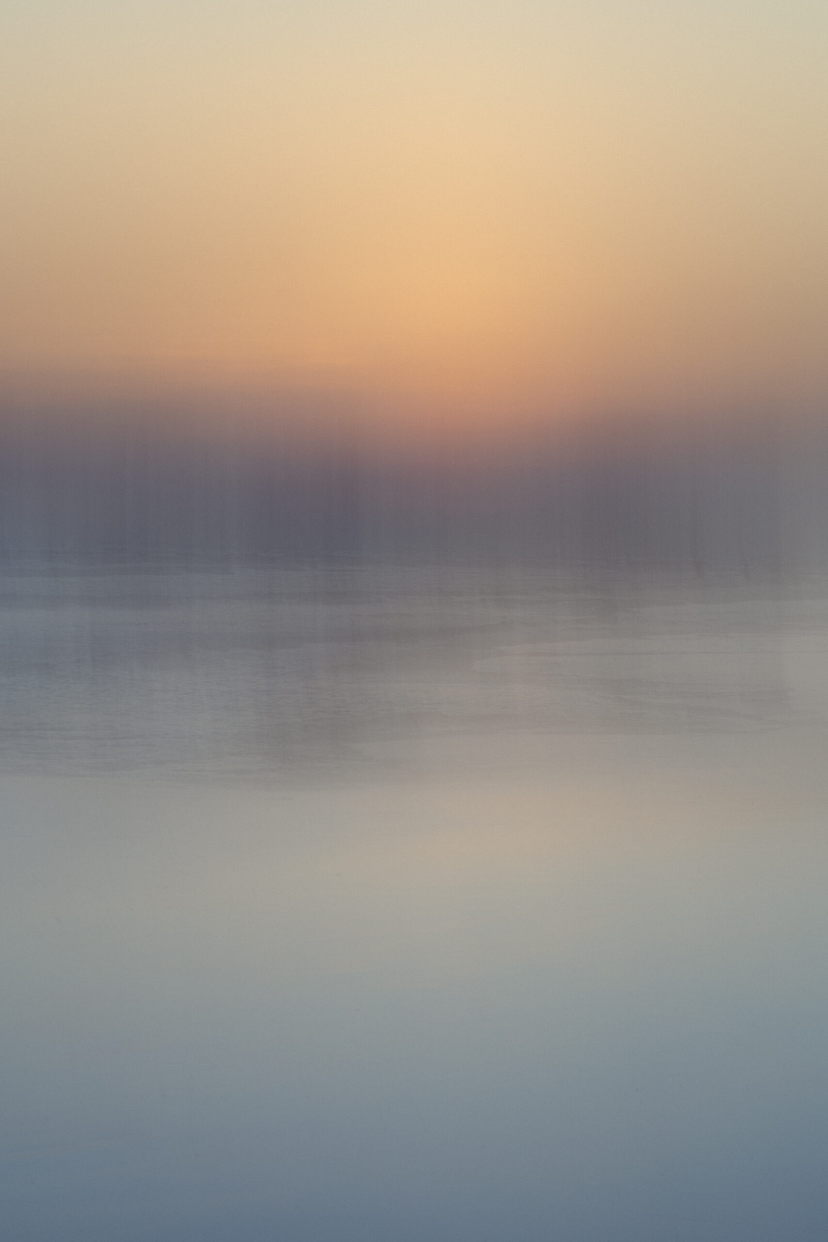 Serene abstract photography by Juan Tribaldos where he has blurred the image of an ocean and soft light of either a sunrise or a sunset into complete dreamy abstraction.