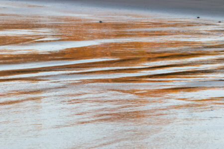 Bronze beach scene focusing on the textures of sand, by Leonardo Ureña.