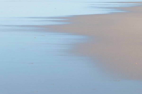 Beach and Ocean photography, showcasing a mindful photographic experience, by Leonardo Ureña. This tranquil image features silvery blue water lapping onto sand.