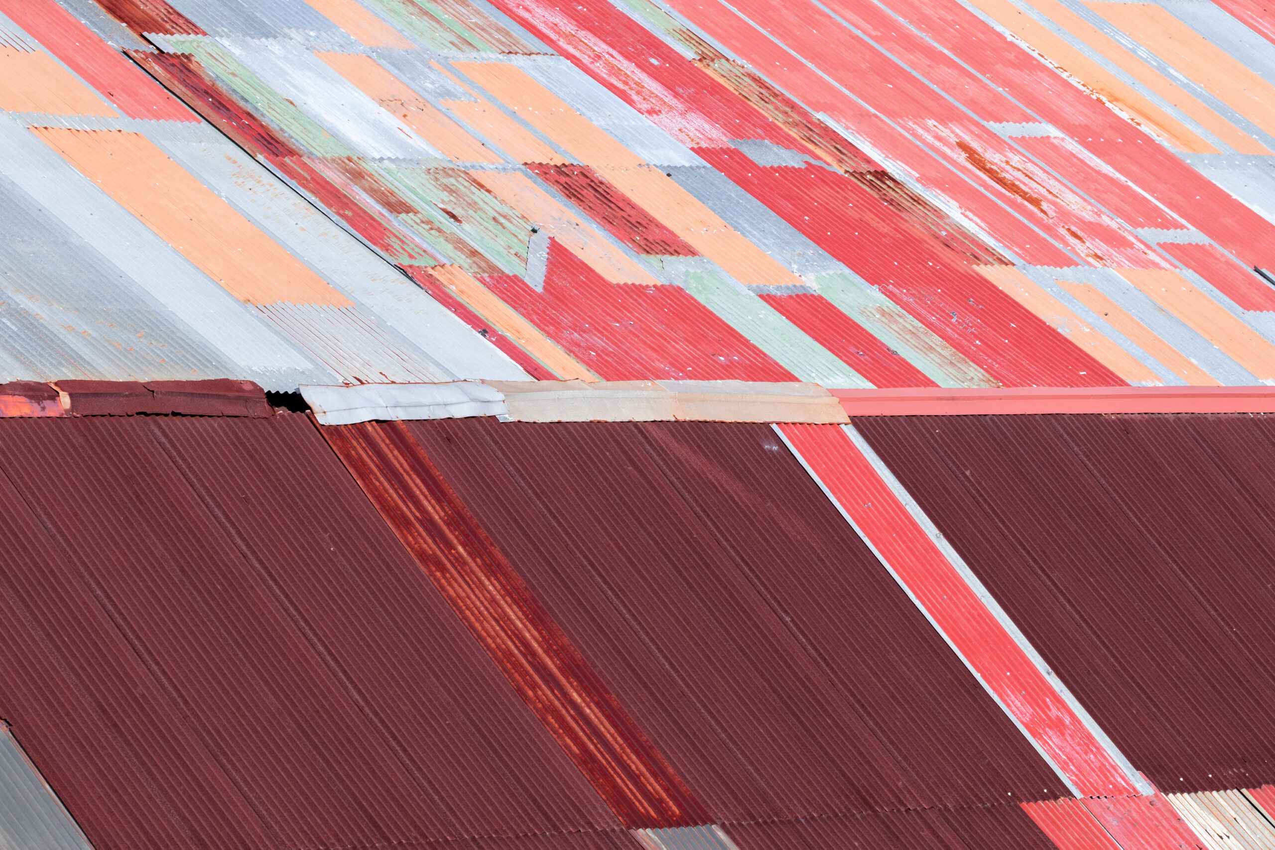 Geometric, abstract rooftop with red, peach and grey colours, showcasing Leonardo Ureña's graphic design background.