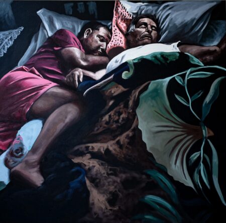 Intimate portraiture featuring two family members lying in bed, enveloped in bedsheets. Strong contrasts of light and dark evoke emotions and rich red and green colour adds to the scene.