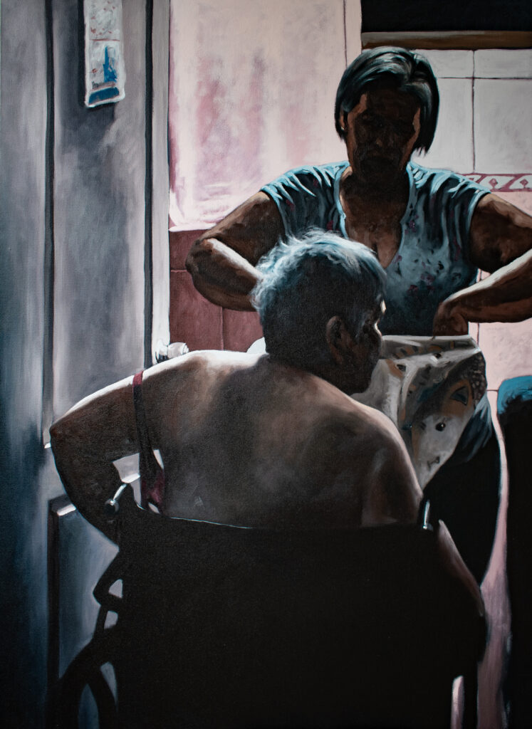 Caregiver painting by, and featured in, Jesus Mejia exhibition, featuring a figure in a wheelchair with their back to us, while a woman helps with some clothing. It's an intimate, tender and quite sad scene.