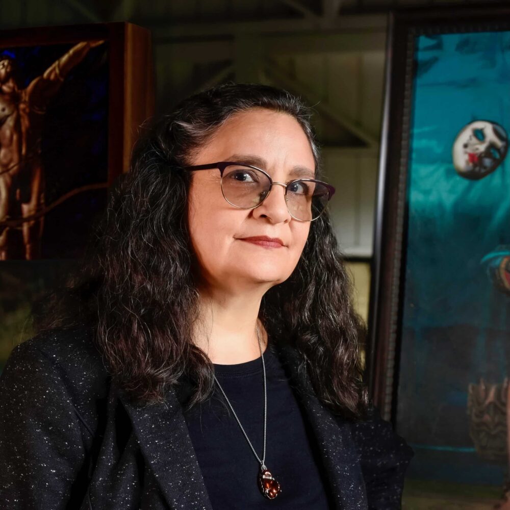 Portrait of lady with dark hair in an art studio. Sylvia Laks - a member of the stained glass association of america.