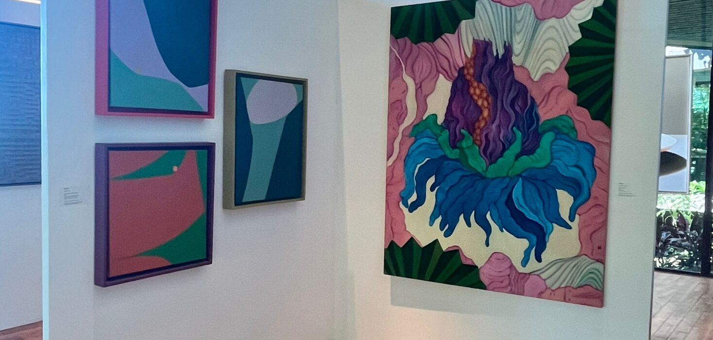 Andaz Art week. A display of bright abstract paintings on white walls.