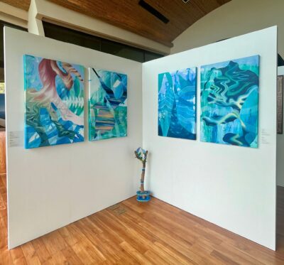 Andaz Art Week featuring 4 bright and blue abstract paintings on a white wall.