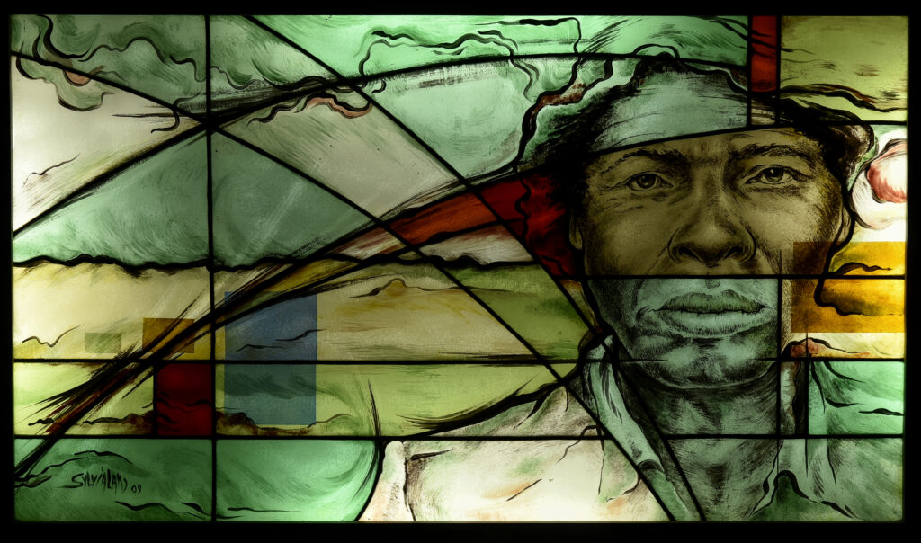 green, yellow and red stained glass figure