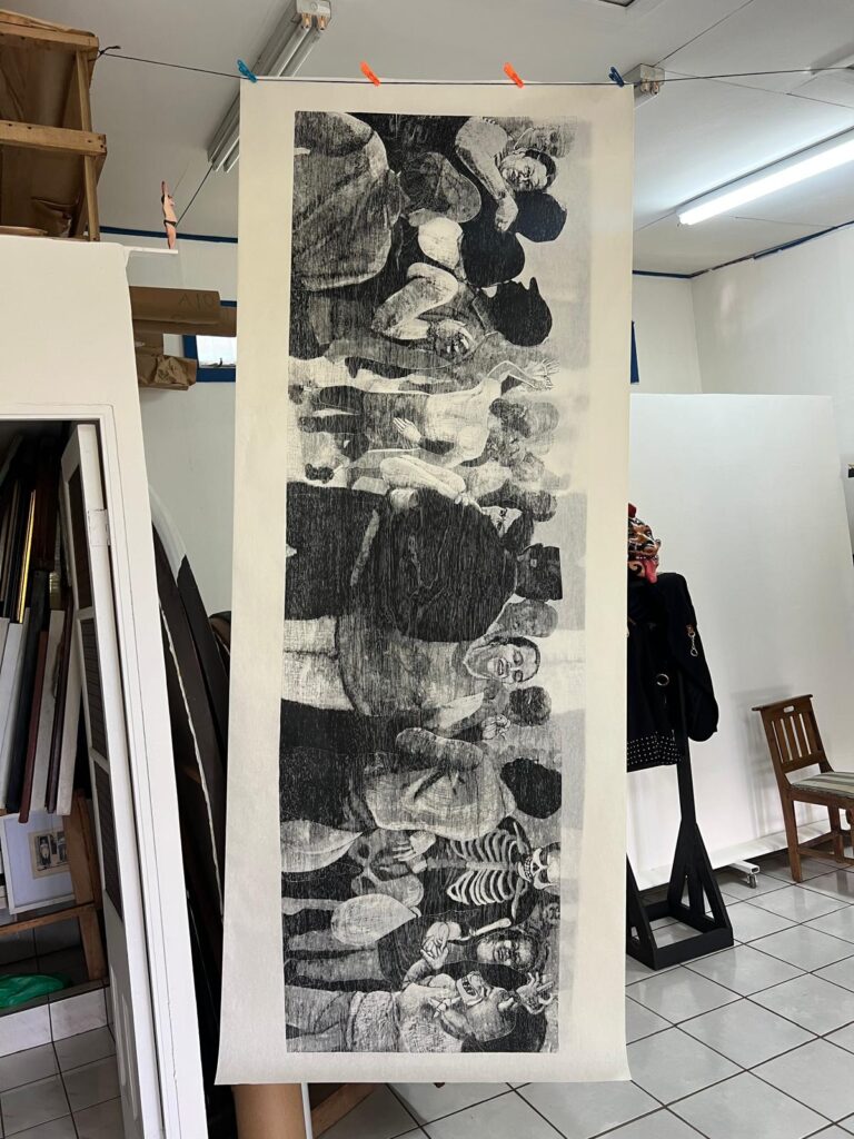 Adrián Arguedas in his Heredia studio with monumental black and white woodcut print, contemporary Latin American figurative art