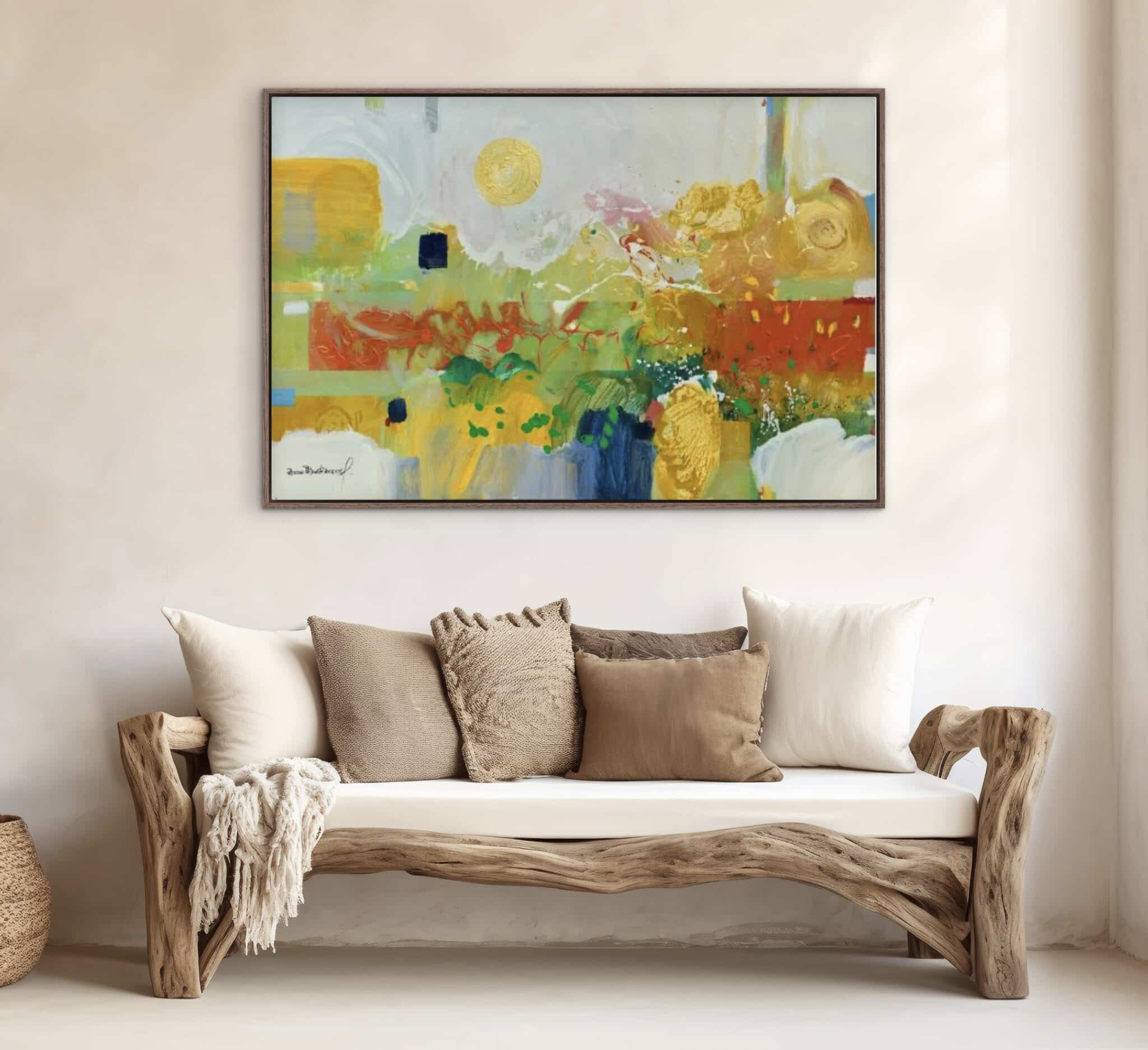 Against a cream-hued wall, Paisaje Soleado is displayed above a rustic wooden sofa, its vivid palette animating the serene space. , an original work available at MÍRAME Fine Art.